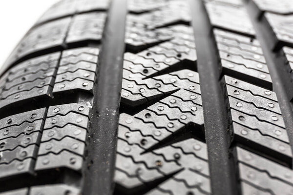 Car tire close up isolated on white background.