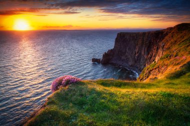 İrlanda 'nın Clare ilçesinde gün batımında Moher Uçurumları.