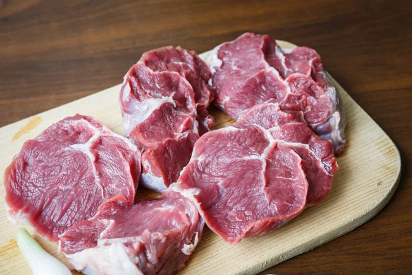 Fresh raw beef on wooden cutting plate — Stock Photo, Image