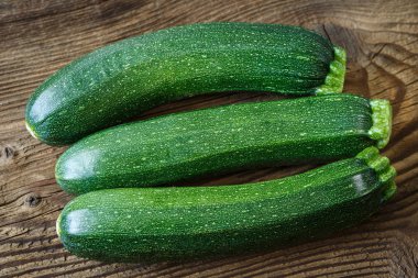 Fresh zucchini on rustic wooden table clipart