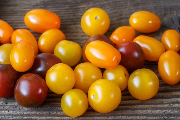 Tomates cereja no fundo de madeira rústica — Fotografia de Stock