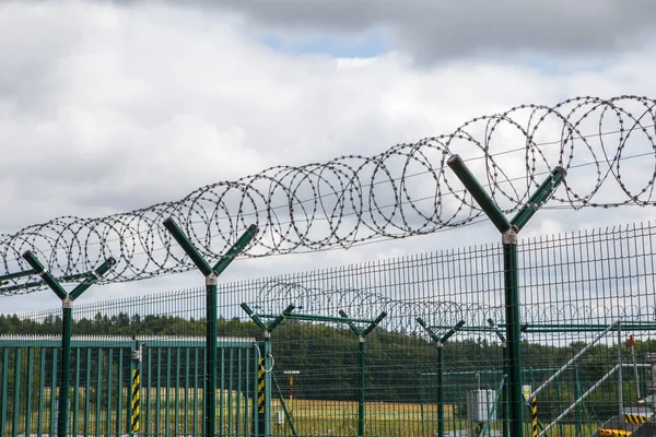 Security fence with a barbed wire. Fence with a barbed wire. — Stock Photo, Image