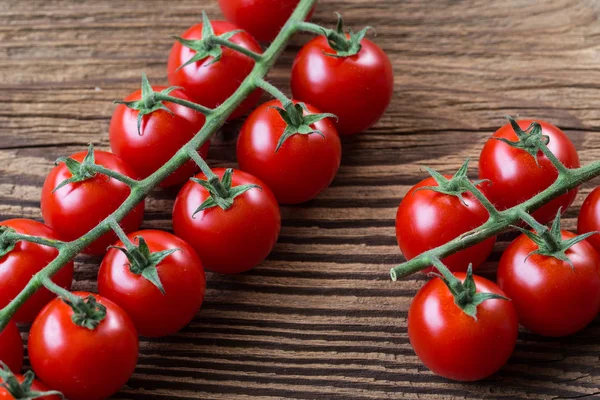 Fresh cherry tomatoes on a brown background. — Stock Photo, Image