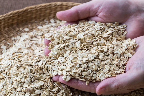 Basket with oat flakes. Dry rolled oatmeal. — Stock Photo, Image