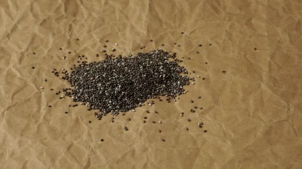 Pouring Chia Seeds Crumpled Paper Background — Stock Video