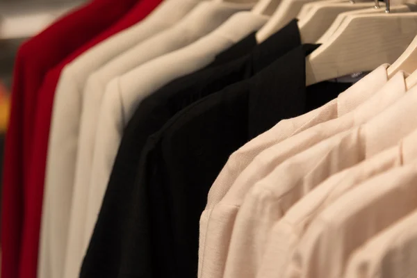 Womens clothes hanging on hangers in store — Stock Photo, Image