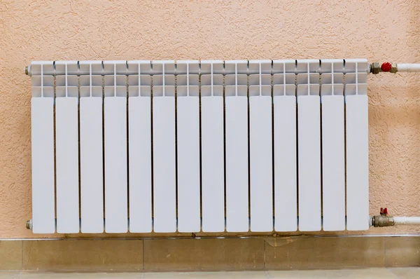 White new radiator on pink wall Royalty Free Stock Images