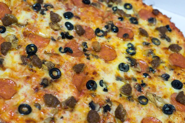 Pizza with salami and black olives — Stock Photo, Image