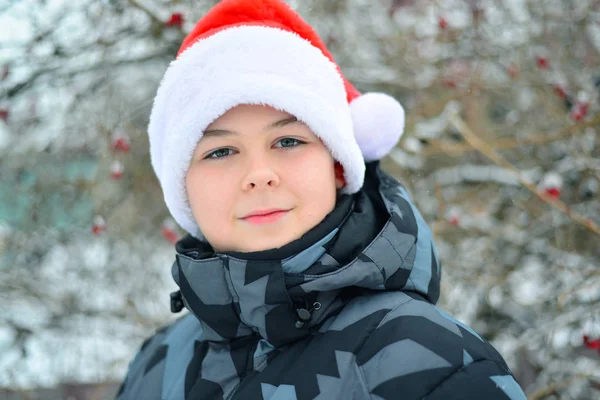 Teen boy in cap Santa Claus outdoor — Stock Photo, Image