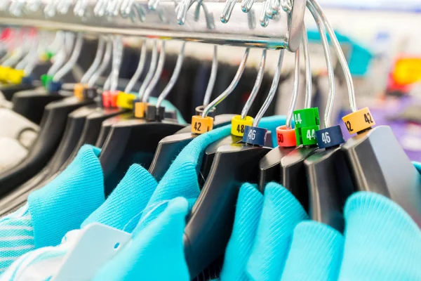 Hangers for clothes in shop with dimensional marks — Stock Photo, Image