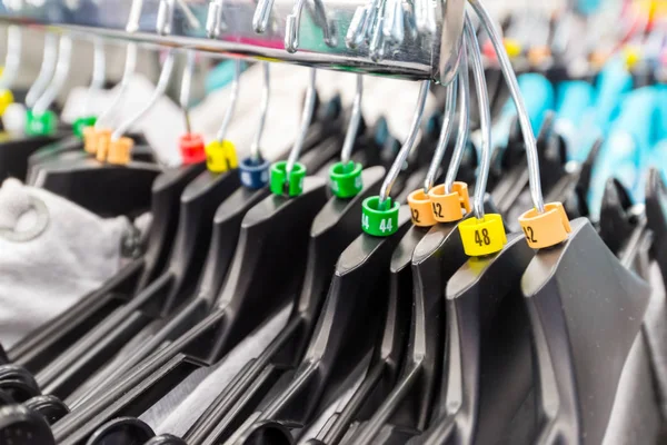 Hangers for clothes in shop with dimensional marks — Stock Photo, Image