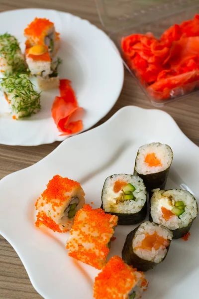 Sushi on the white plate on table