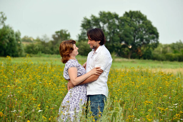 Happy middle-aged couple on nature in summer