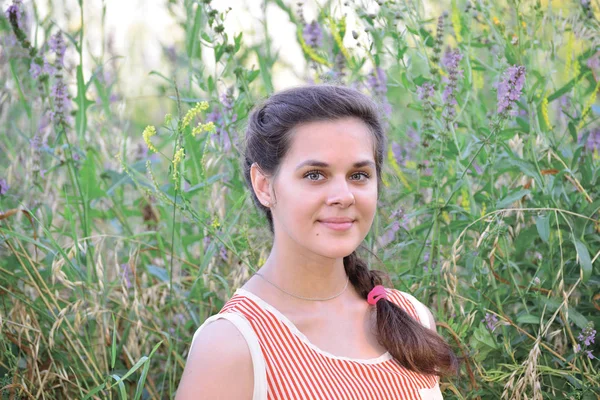 Russian girl teenager in background of wildflowers — Stock Photo, Image