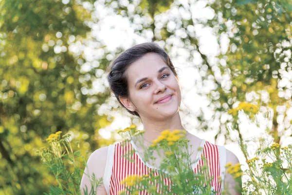 Smiling girl on nature near tansy — Stock Photo, Image