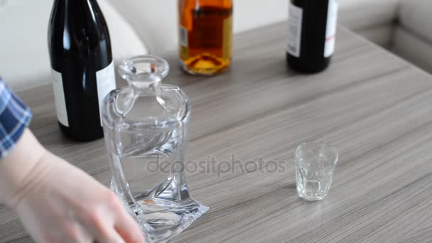 A female hand pours Russian vodka from a carafe into glass — Stock Video