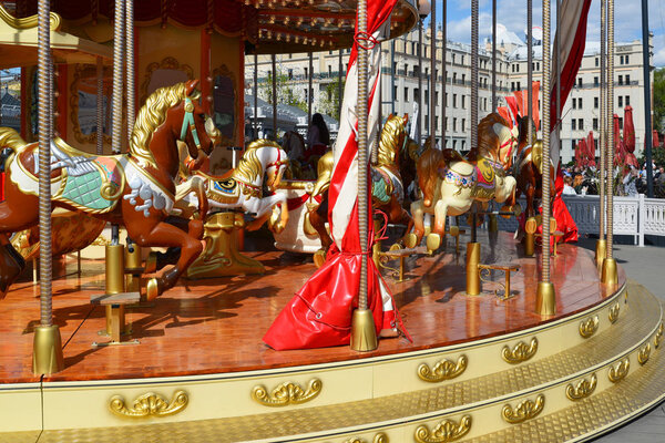 Fragment of children's merry-go-round with horses in Moscow, Russia