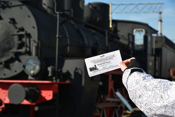 Moscow, Russia - April 1.2017. Childs hand keeps a discount ticket in Museum of History of Railway Transport Development