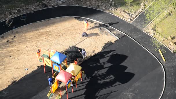 Moscow, Russia - July 19. 2017. Workers lay asphalt on playground, top view — Stock Video