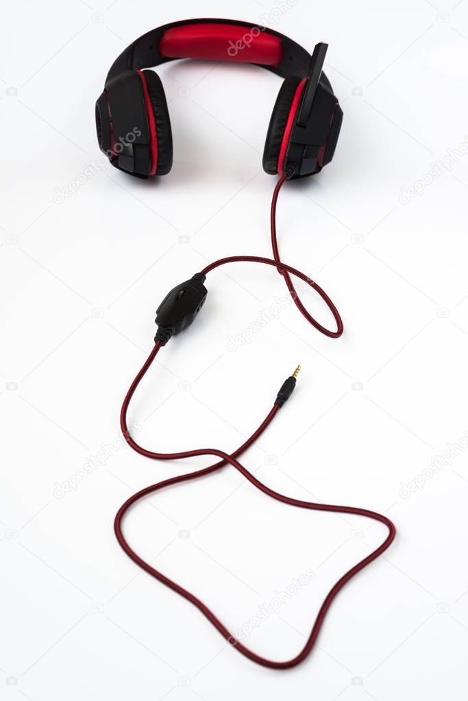 black gaming headphones with cord on white background