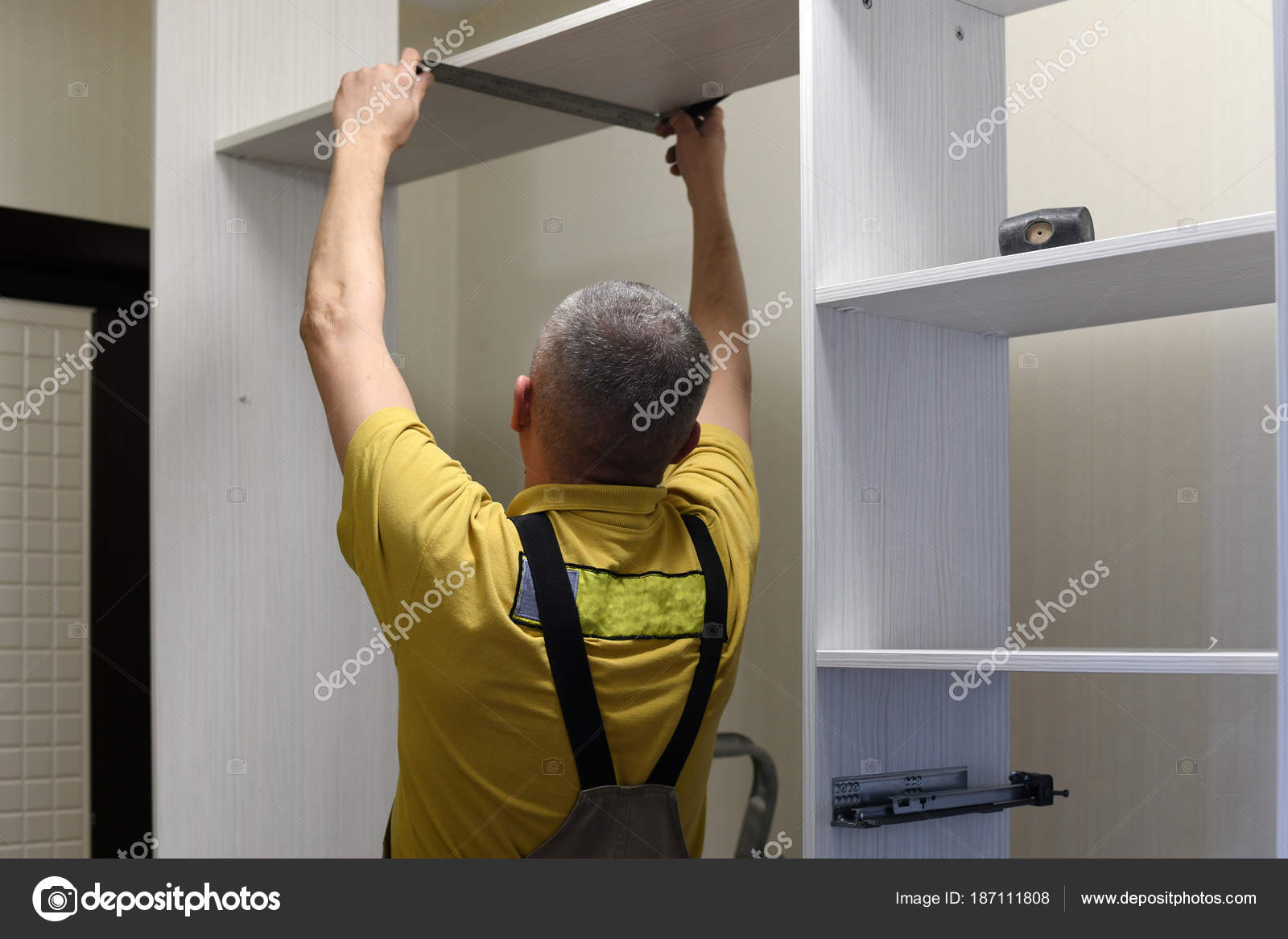 The Master Installs A Wardrobe In Apartment Stock Photo C Olenka