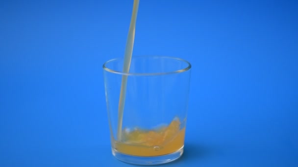 Apricot juice is poured into glass in slow motion — Stock Video