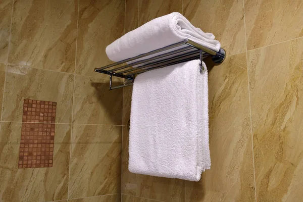 White terry towels in bathroom on the holder on wall — Stock Photo, Image