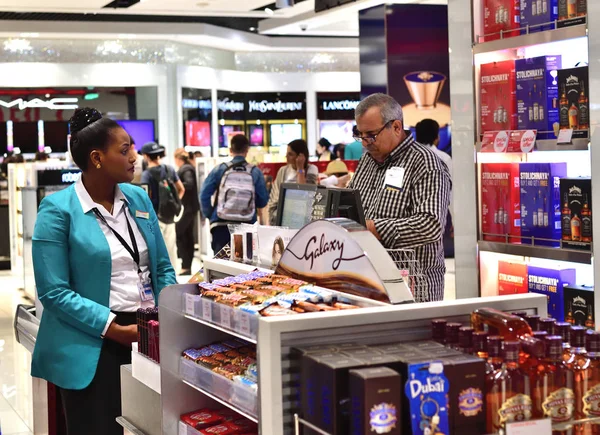 Дубай, ОАЭ - 10 апреля. 2018 год. Покупатель при оформлении в магазине беспошлинной торговли в аэропорту — стоковое фото