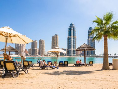 Doha, Qatar - Nov 11. 2019. Beach on background of skyscrapers on the Pearl Island