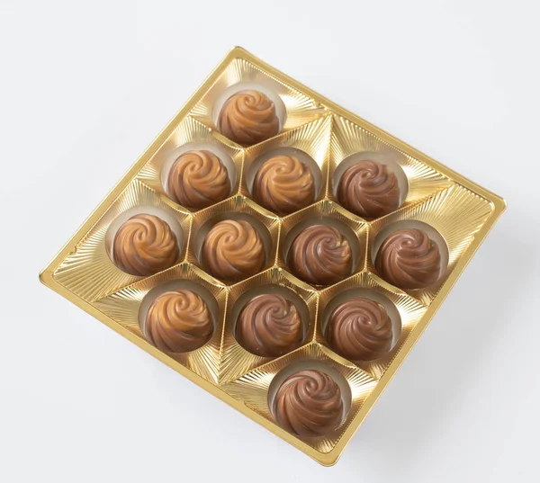 Milk chocolate candies packaged on a light background — ストック写真