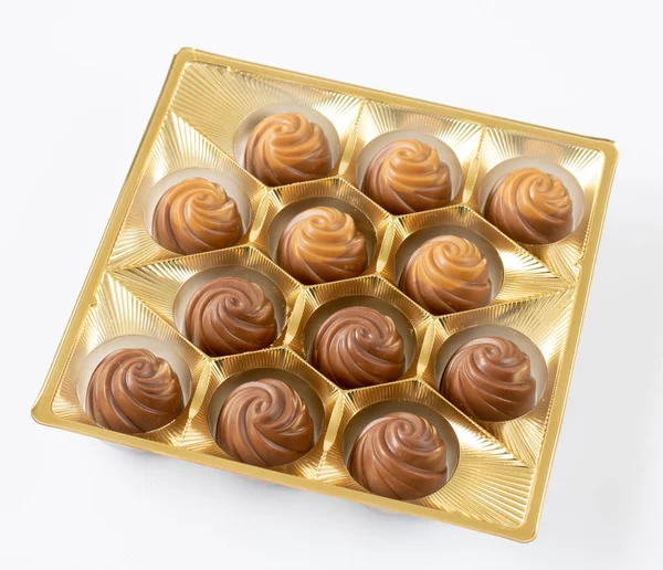 Milk chocolate candies packaged on a light background — Stok fotoğraf