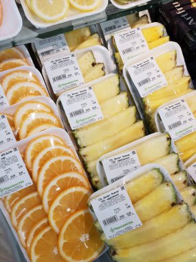 Moscow, Russia - Jan 27. 2020. Fresh Pineapples and orange at the Perekrestok store