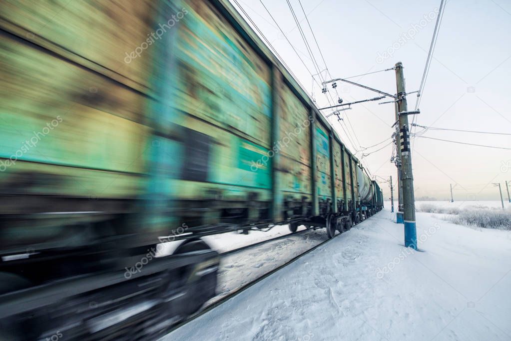 Winter railway and train with cargo.