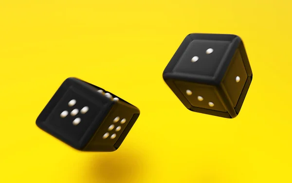 Thrown black dice close-up on a yellow background.