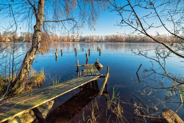 Swedish wooden bridge with first transparent ice reflection — Stock Photo, Image