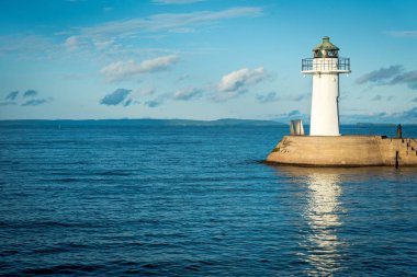 Harbor lighthouse in Swedish marina clipart