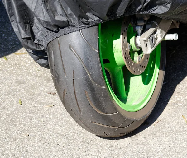 detail of green motorbike wheel in my town