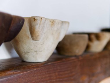 Tahta bir masanın üstünde mermer havan topu. 