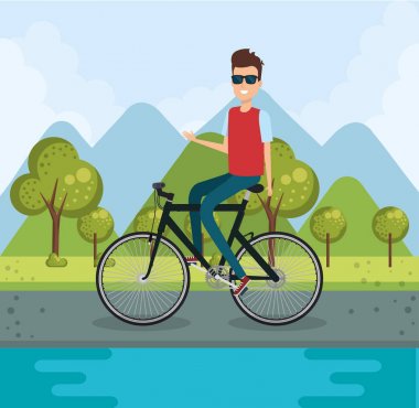 Parktaki bisikletli genç adam.