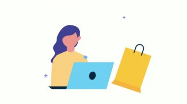 Alışveriş çantasıyla dizüstü bilgisayar kullanan genç kadın.