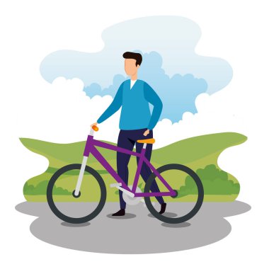 Park manzarasında bisikletli genç bir adam.