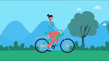 Parkta bisiklet süren bir kadın.