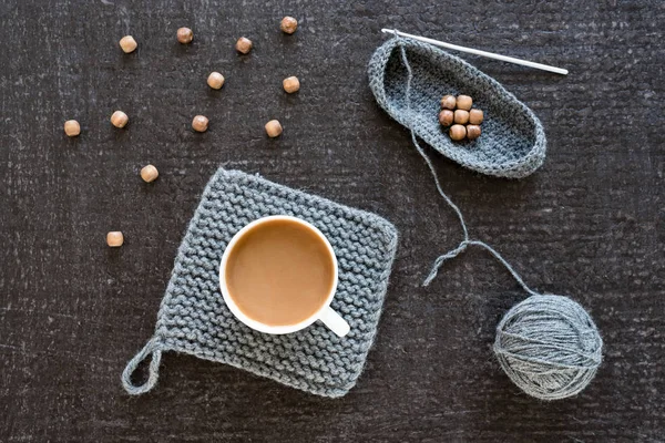 Coffee, wooden beads and crocheting on black — Stock Photo, Image