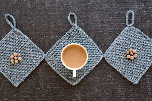 Coffee, wooden beads and knitted props on black — Stock Photo, Image