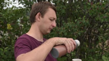 Adam açık havada çay içme termos