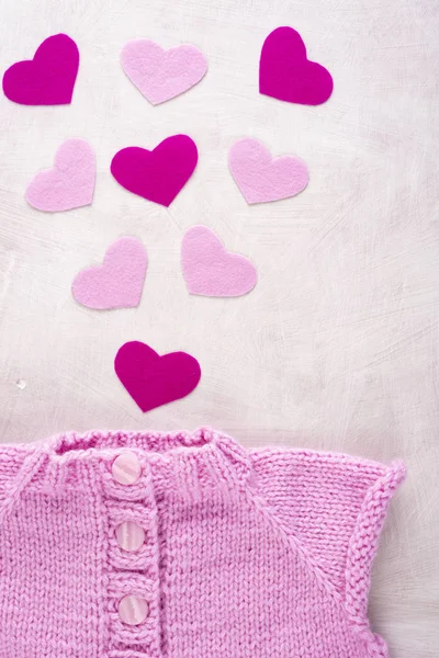 Pink sweater with hearts made of felt