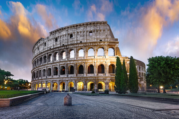 Colosseum in Rome at sunset with lights, Italy
