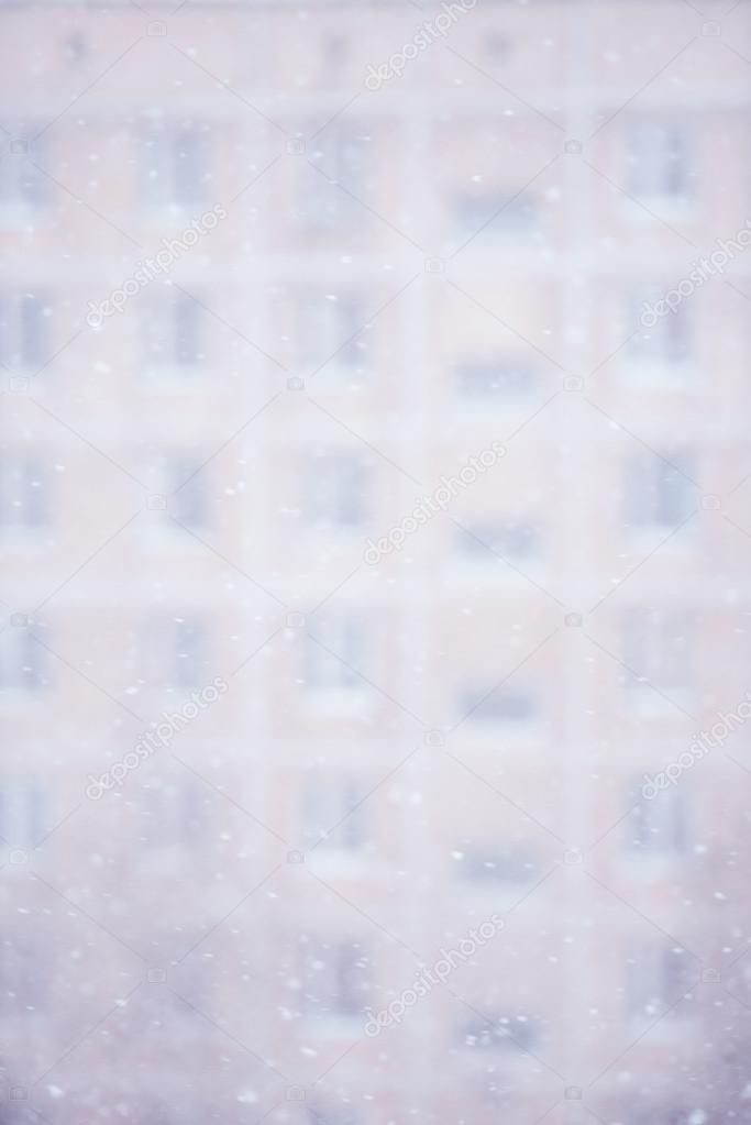 Snowfall against building facade