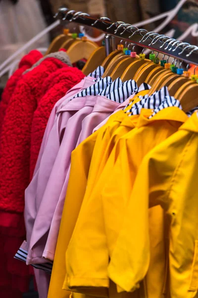 Bright raincoats at store — Stock Photo, Image