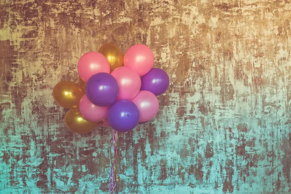 Bright balloons on textured wall — Stock Photo, Image